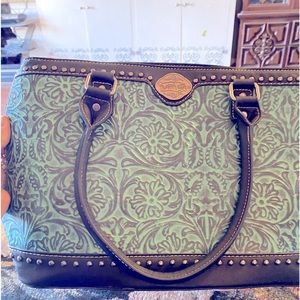 This is a beautiful large TRINITY RANCH bag. Many pockets & zipped compartments